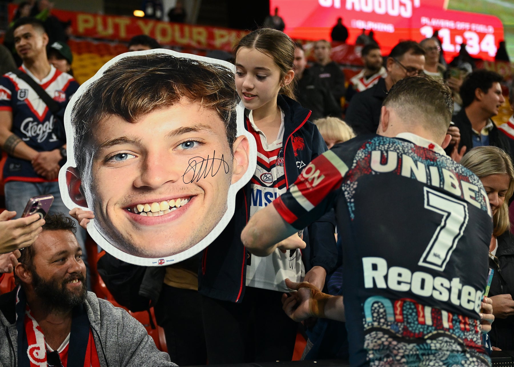 Supporters holding Sports Heads at a live game