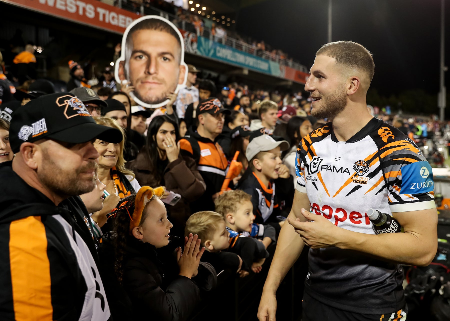 Supporters holding Sports Heads at a live game