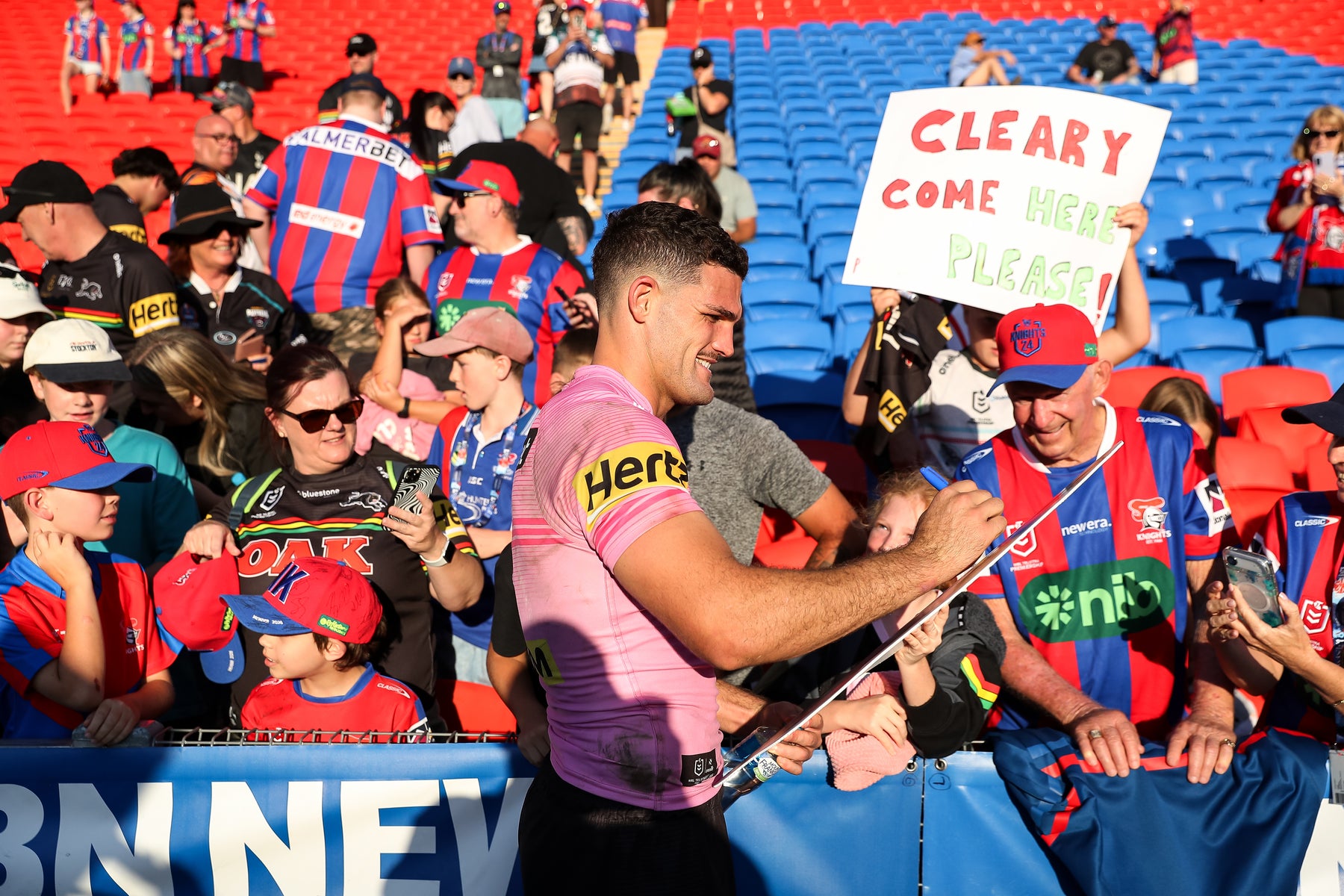 Supporters holding Sports Heads at a live game