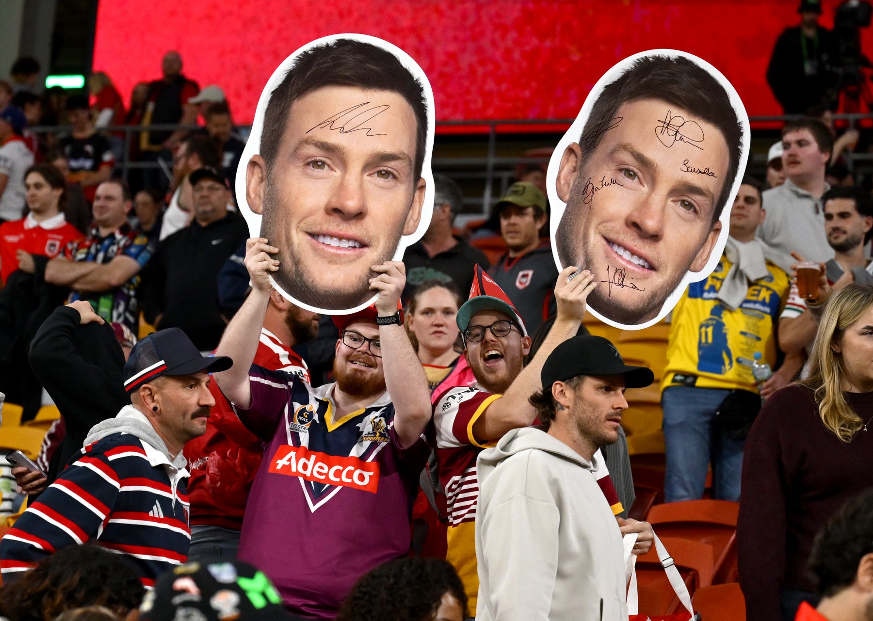 Supporters holding Sports Heads at a live game